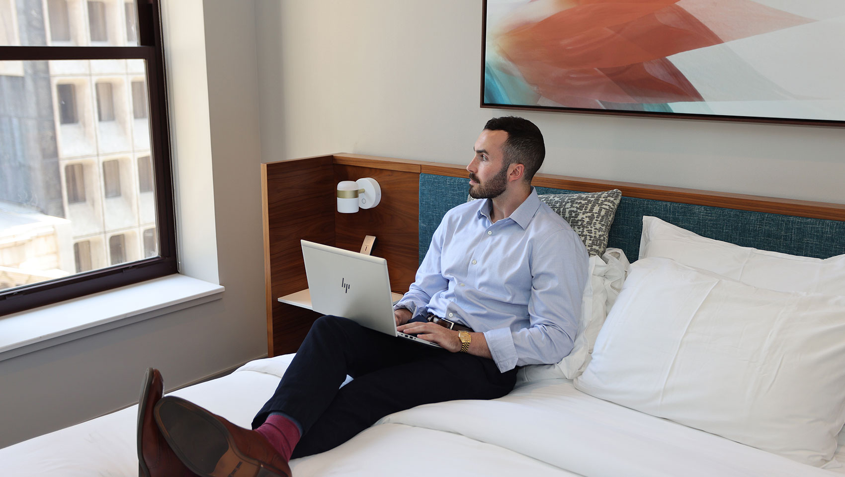 Man sitting on bed in hero suite