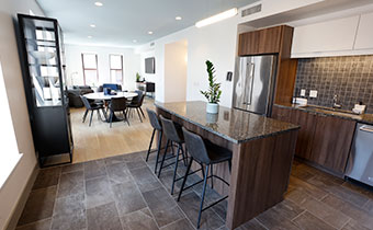 rockefeller suite kitchen with dining and living room areas in background