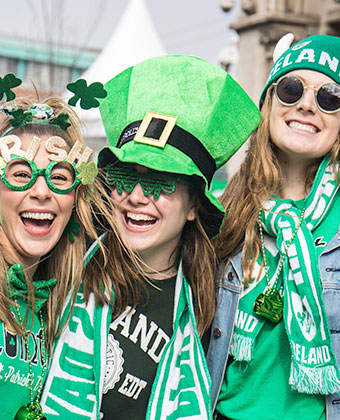 people wearing green hats and scarves